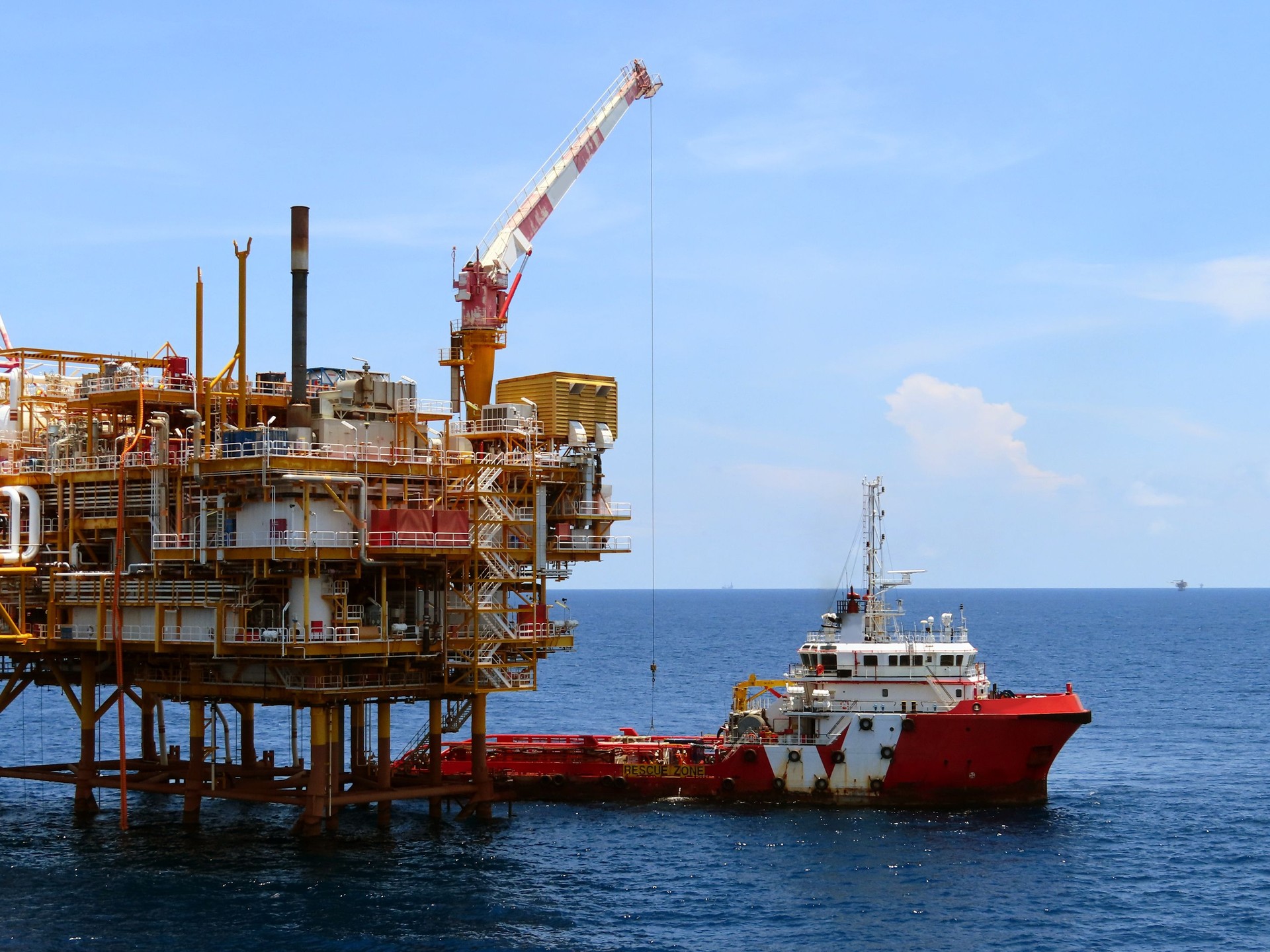 Supply boat transfer the cargo for supporting oil and gas industry and moving cargo from the boat to the platform. Boat is waiting transfer cargo and crews to platform.